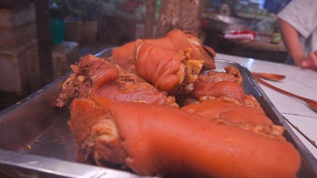 Steaming pig trotters on a tray