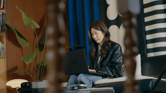 Woman lost in deep thought while working on her laptop
