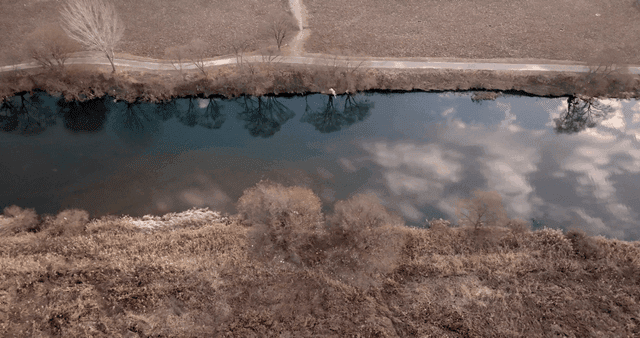 A calm river reflecting the sky