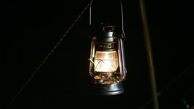 A bright lantern hanging in the dark night