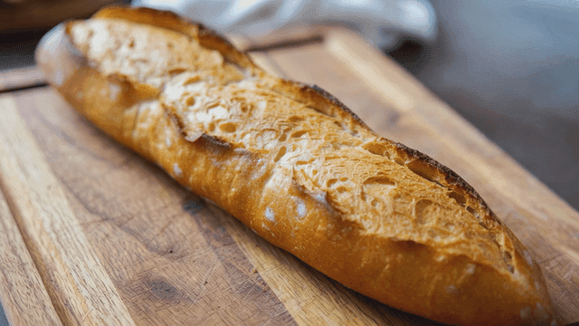 Freshly baked baguette on a wooden board
