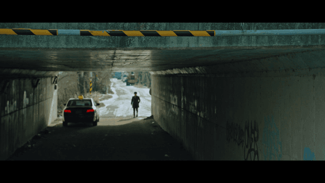 Person walking to taxi in tunnel