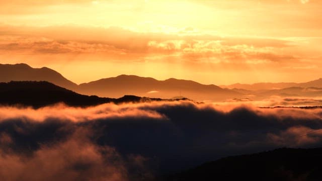 Sunrise over misty mountains