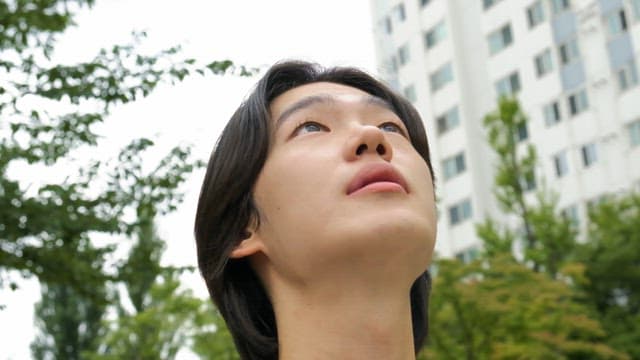 Man looking up in an urban area