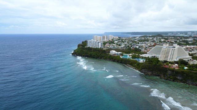 Coastal View with a Resort Atop a Blue Cliff