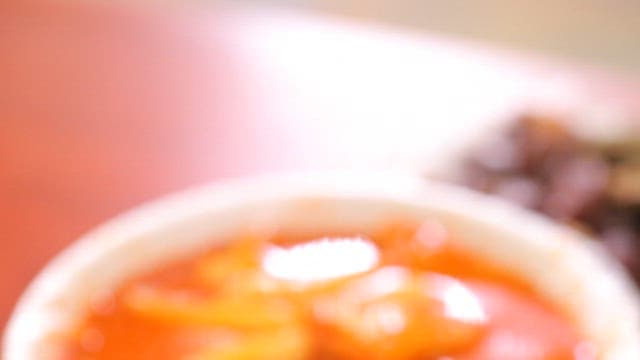 Bowl of spicy tteokbokki on a table