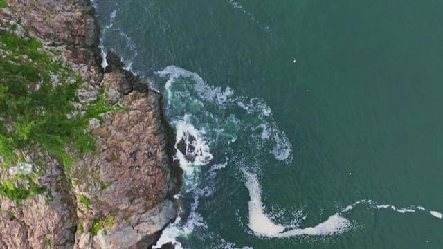 Waves crashing against rocky cliffs