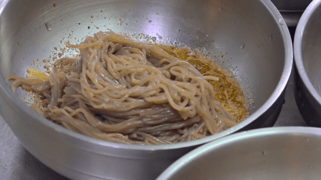 Shiny perilla-oil makguksu served in metal bowl