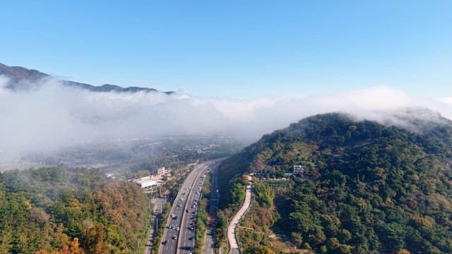 Highway winding through misty mountains