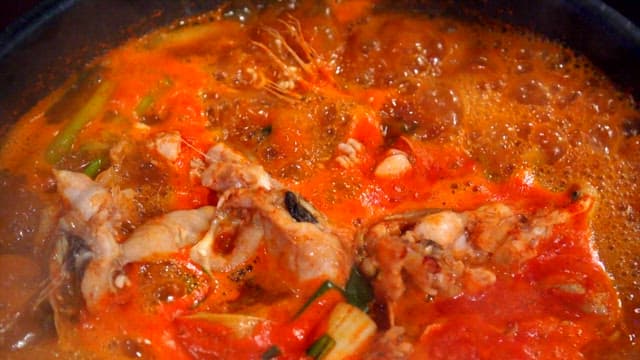 Spicy shaggy sea raven stew boiling in a pot