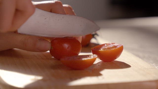 Slicing Tomatoes on a Wooden Board