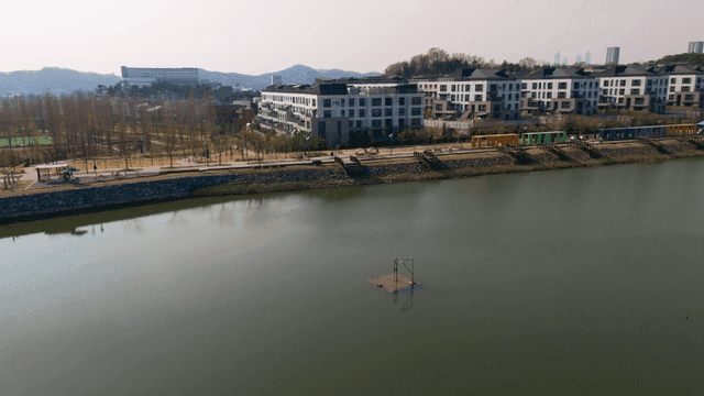 Tranquil lakeside park with modern buildings