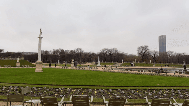 Quiet park lawn with statues and greenery