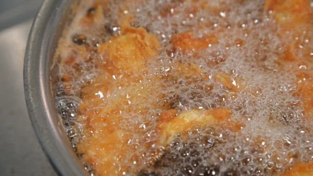 Golden-brown fried food cooking in hot oil