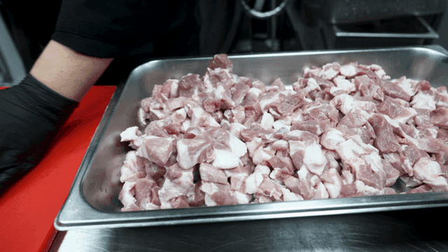 Chopped pork on red cutting board