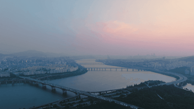 Vast Han River beneath bridge connecting Seoul