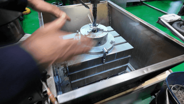 Machine that processes metal with drill in factory