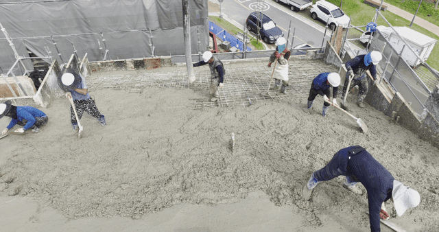 Workers pouring concrete on a building site