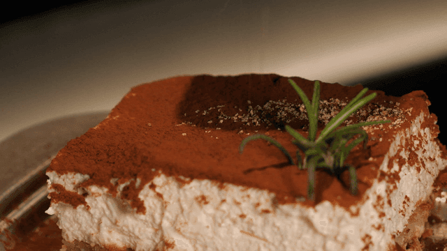 Piece of tiramisu sprinkled with cocoa powder