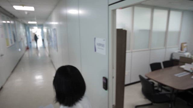 Researcher walking down the hallway of a laboratory building