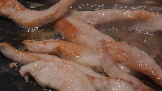 Pork neck sizzling on a hot pan