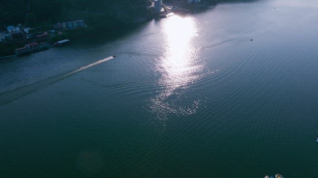 Serene river scene with boat creating ripples