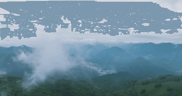 Misty mountains with a distant village