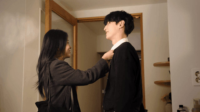 Couple smiling and adjusting clothes