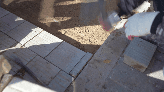 Worker laying bricks on a construction site