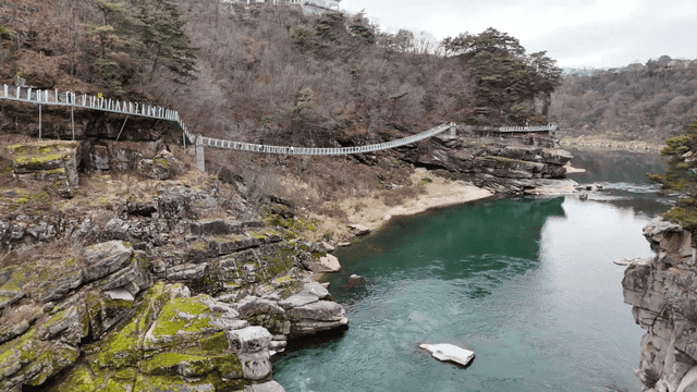 Scenic river with a suspension bridge
