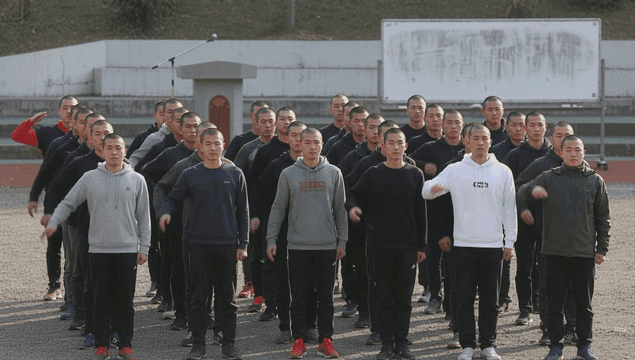 Young men entering military saluting in formation