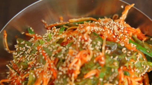 Appetizing Bibim Jjolmyeon with fresh vegetables and sesame seeds