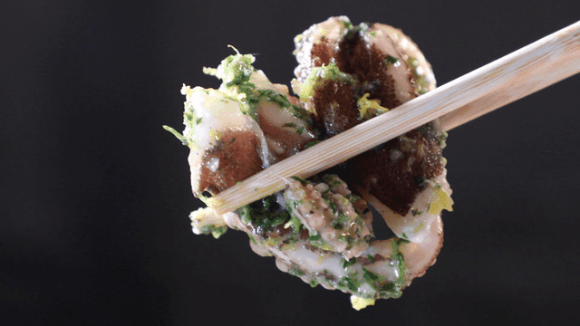 Chopsticks holding seasoned octopus