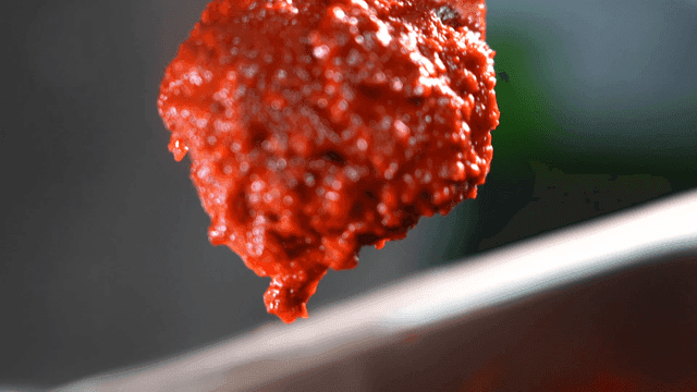 Gochujang seasoning scooped out with ladle