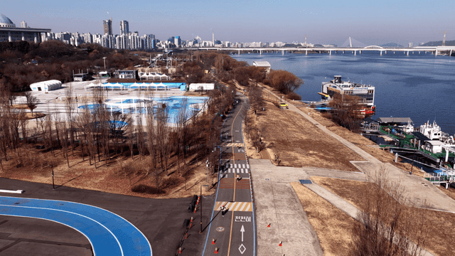 Riverside park with city skyline