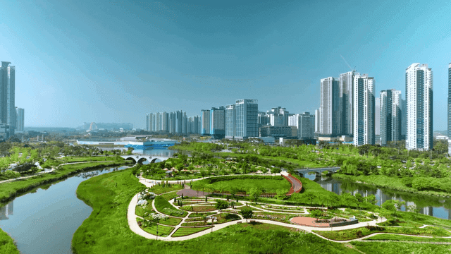 Modern city landscape with lush greenery.