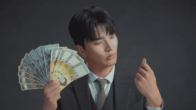 Man smiling at the Bitcoin in his hand