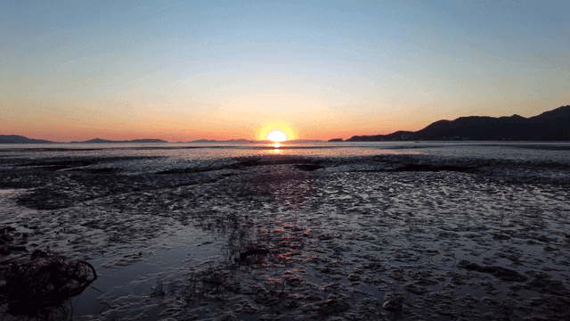 Sunset over a tranquil coastal landscape