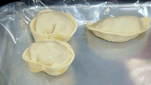 Preparing dumplings on a tray