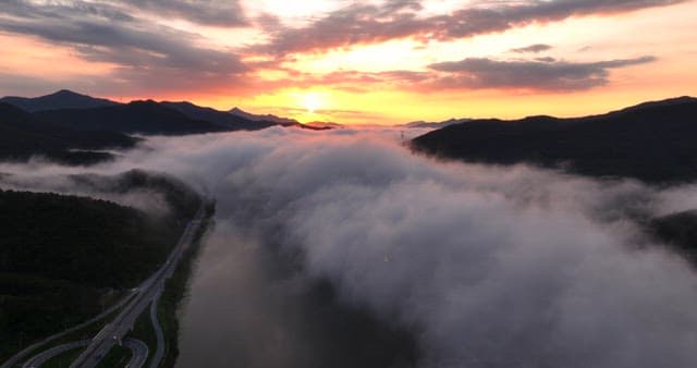 Sunset over mountains with clouds
