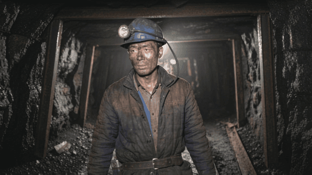 Miners working in dark underground tunnels