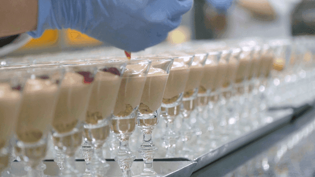 Strawberry jam on top of desserts prepared in kitchen
