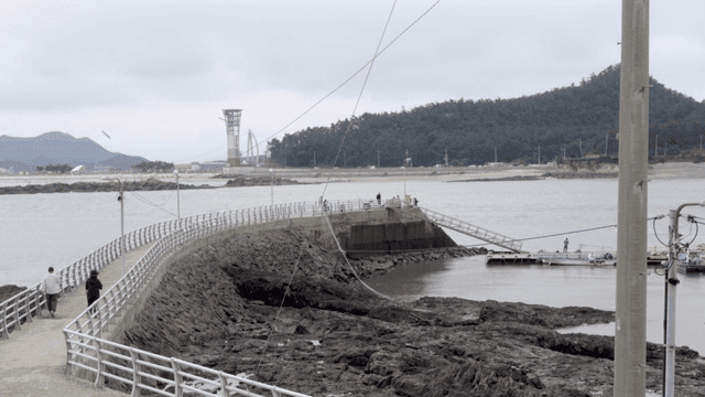 Coastal walkway with distant mountains