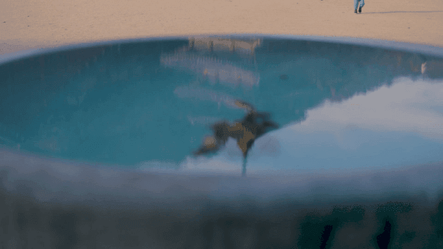 Walking family and temple roof near a shallow puddle