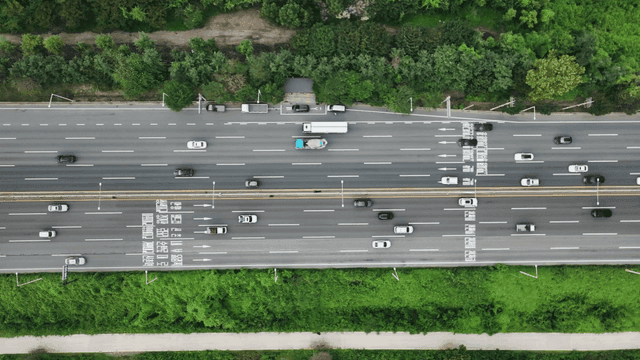 Busy highway surrounded by greenery