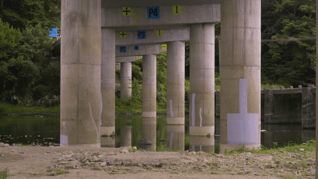 Concrete bridge pillars over a calm river