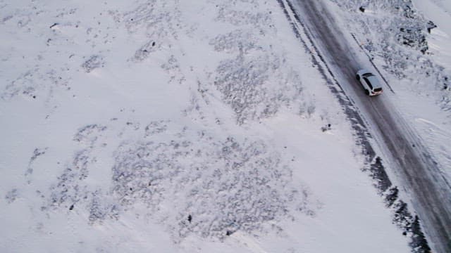 Car driving on a snowy mountain road