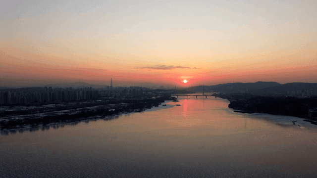 Sunset over a city skyline and river