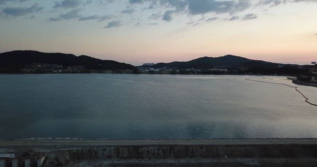 Calm sea with distant city lights