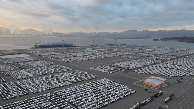 Wide loading dock near port with numerous cars